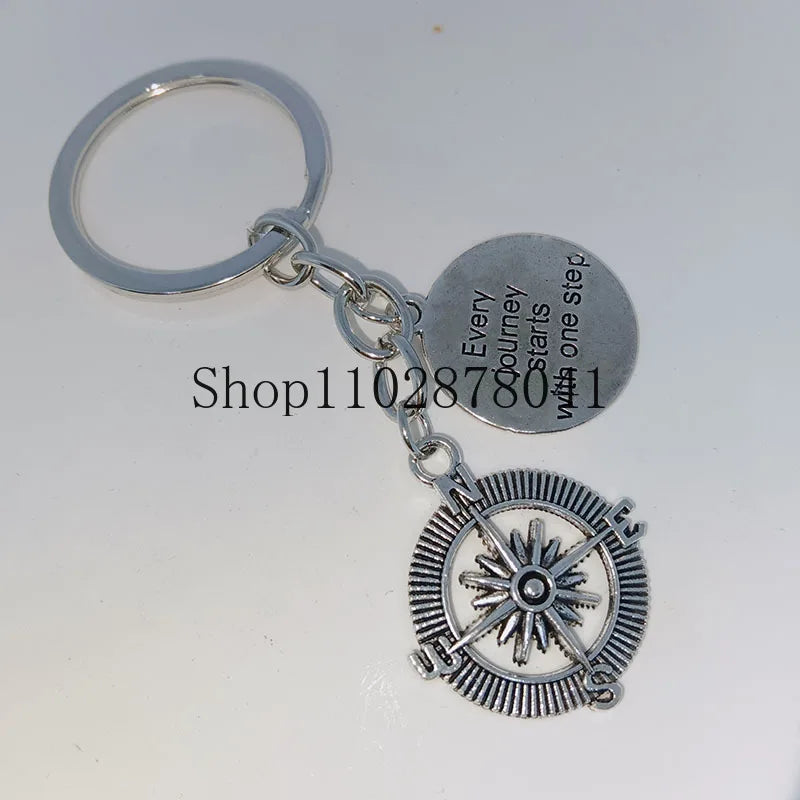 Keychain With The Positive Message ("Every journey starts with one step") With Compass